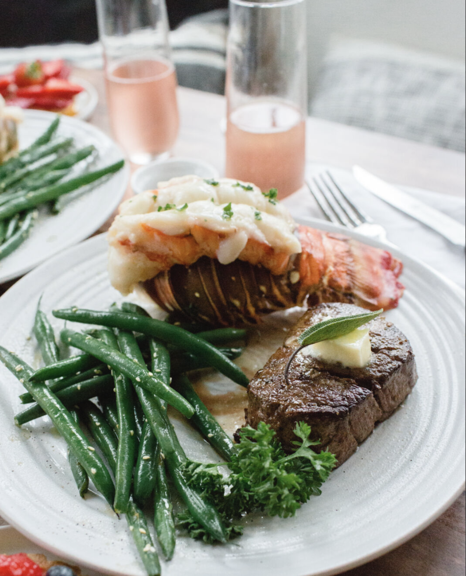 salmon, asparagus, and lemon wedges on a wooden cutting board